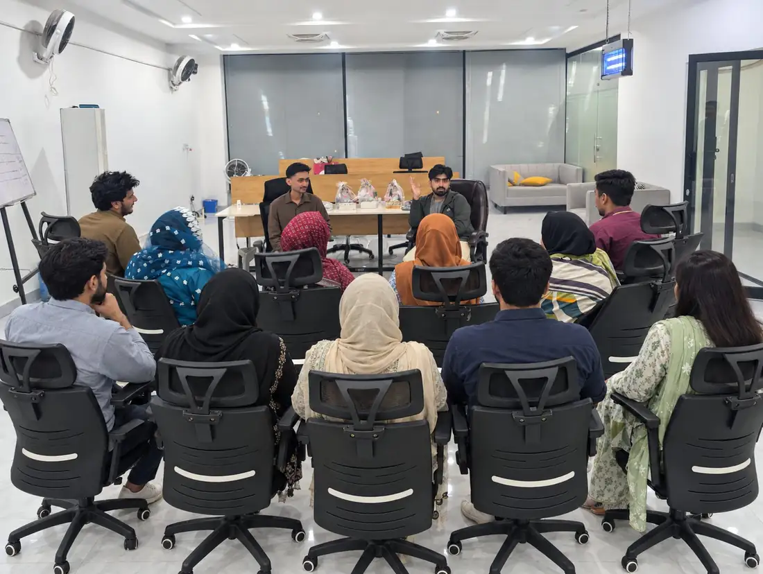 Topwebs team seated in a circle during a session in the Lahore office