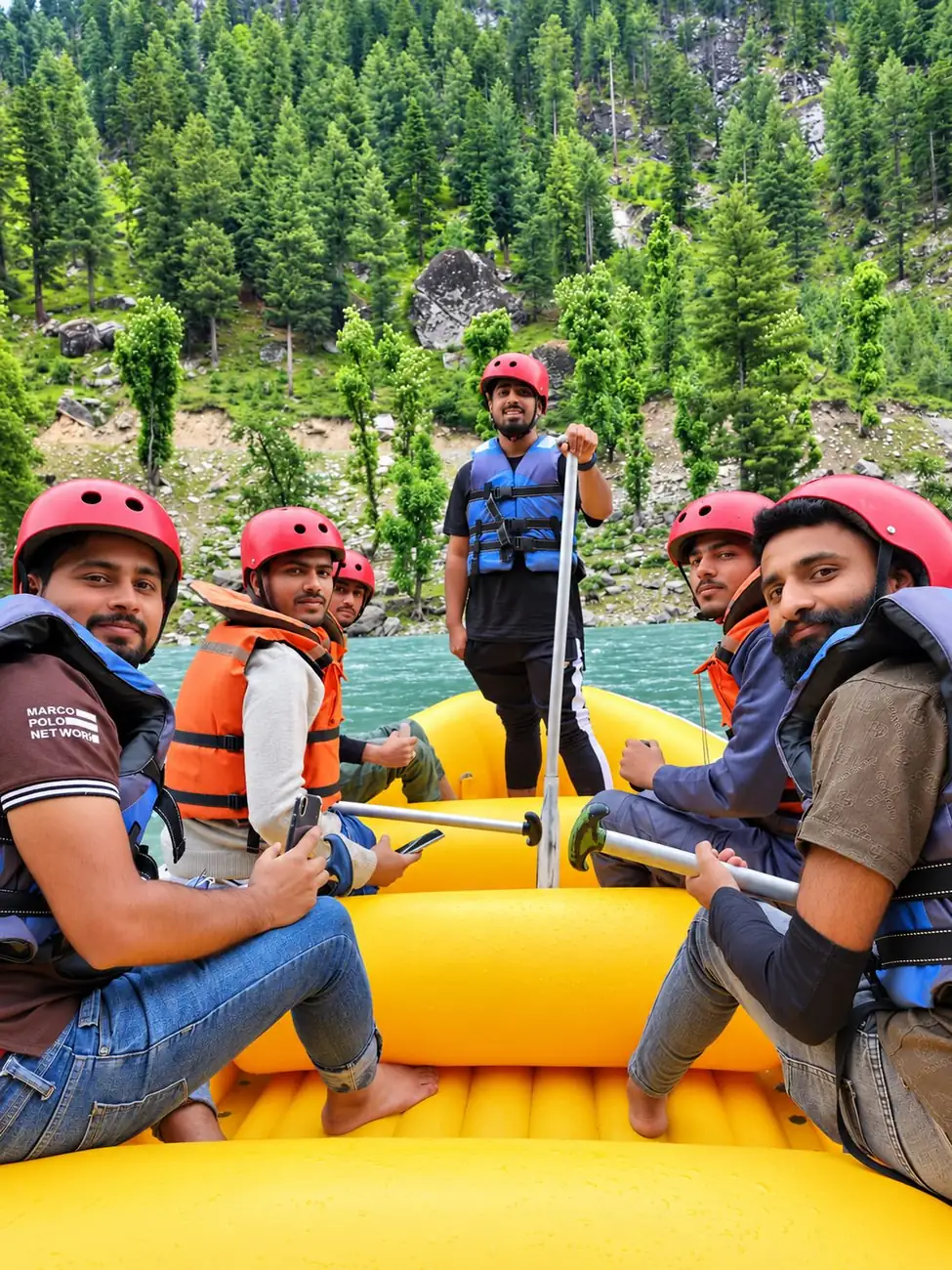 Topwebs team members in helmets and life jackets on a yellow raft on a mountain river
